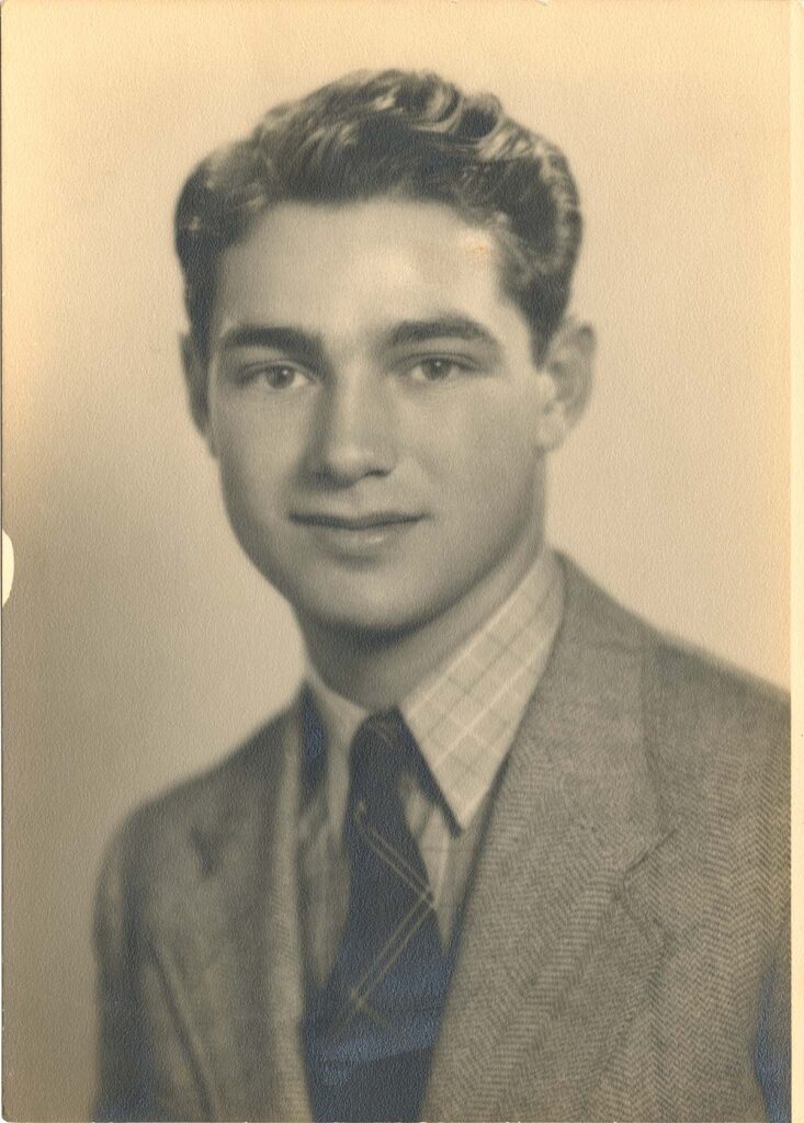 Faded vintage portrait of a young man scanned from an original photo, showing age-related discoloration and wear