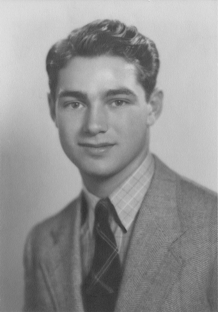 Restored black and white portrait of a young man with enhanced clarity, contrast, and damage digitally repaired